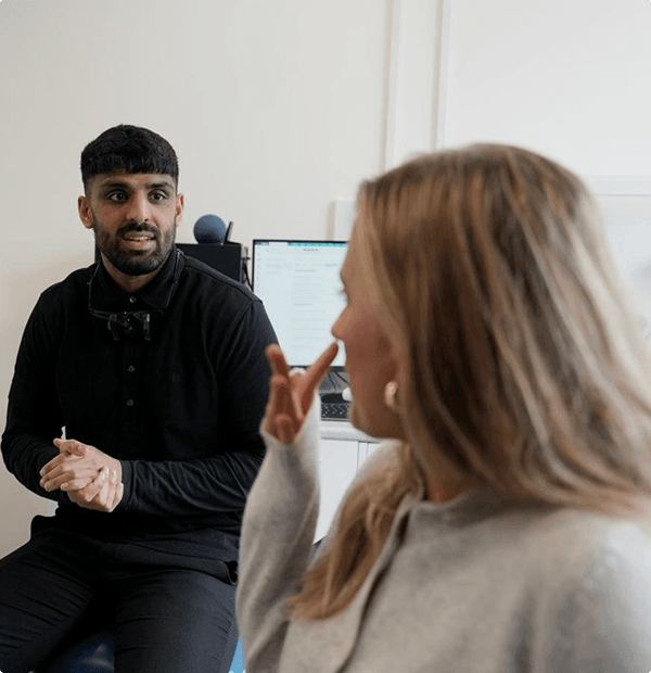 Dr Naeem Ashfaq talking with a patient during a consultation